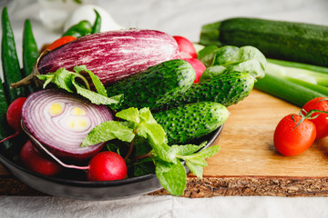Different fresh colorful vegetables on a wooden tray. Close up view, healthy eating.