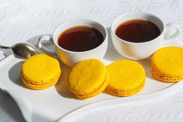  Macaroons and coffee cup on white wood table.