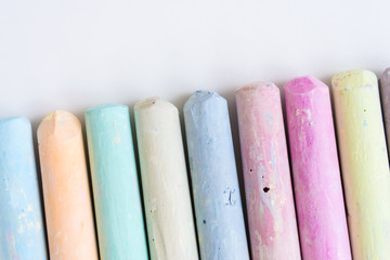 Colored crayons, laid out in a row. Top view, close-up. Background, texture. Banner.