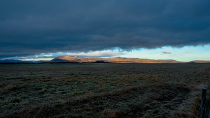 A gigantic cloud covers almost the entire sky except the horizon in Iceland