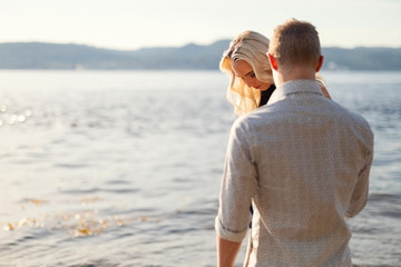 Couple in love holding hands and walking at the beach