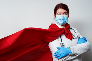 Doctor wearing surgical face mask in superhero cape.