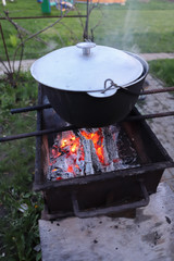 cooking fish soup on the grill in a pot for the family in the fresh air, cooking on the grill, proper nutrition in the campaign