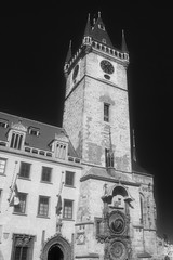 Fototapeta na wymiar The tower of the Old Town Hall in Prague, on which the astronomical clock is located. Black and white.