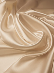 Beautiful smooth elegant wavy beige / light brown satin silk luxury cloth fabric texture, abstract background design. Copy space.