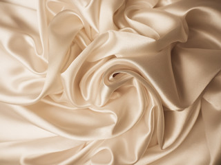 Fototapeta premium Beautiful smooth elegant wavy beige / light brown satin silk luxury cloth fabric texture, abstract background design. Copy space.