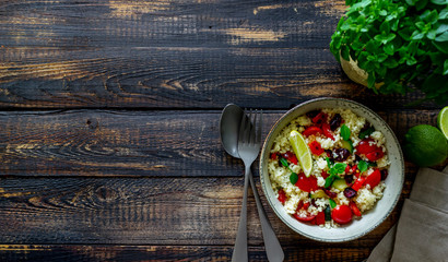 Couscous salad with tomatoes, peppers, courgettes and cranberries. Vegetarian food. Diet. Healthy eating.