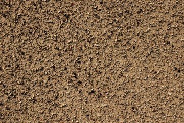 Texture rough stucco interspersed with small river stone