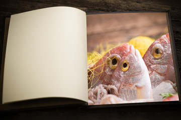 A vintage menu book and image as insert.Fresh fish