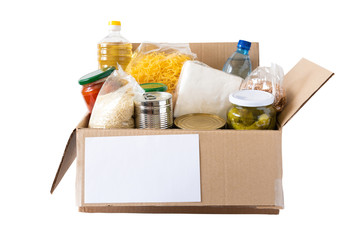 Cardboard box with oil, canned food, cereals and pasta.