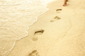footprints in the sand on the beach