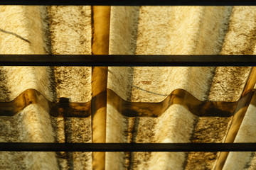 Translucent old roof tiles that are exposed to sunlight. © Puripatch