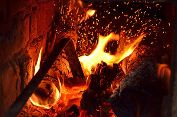 Sparks from fire in fireplace with bokeh balls.