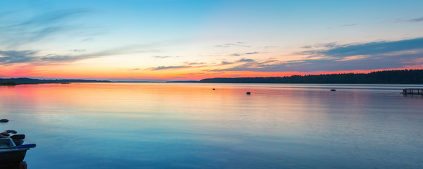 Obraz premium Beautiful landscape with calm sunset over forest lake