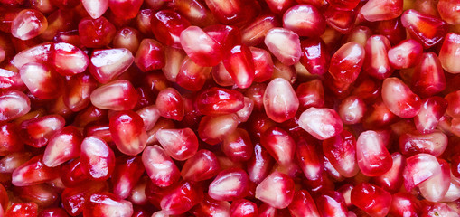 Pomegranate seeds background texture. Pattern. Close up. Healthy food.