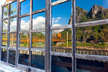 Vintage window pane reflecting mountain View Vang Vieng Laos