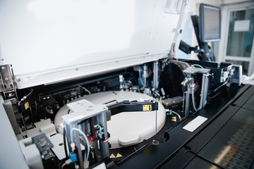 Automatic robot microbiologist analyzing test tube of blood samples for viruses. Concept vaccine search coronavirus 2019-nCoV