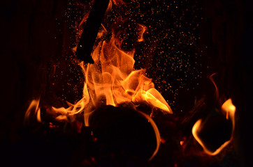 Sparks from fire in fireplace with bokeh balls.