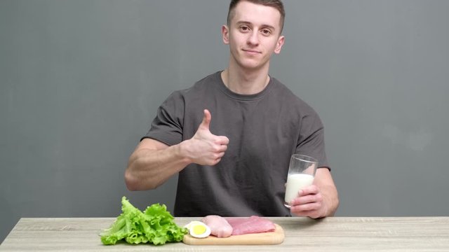 Healthy eating concept. Man of athletic build eats healthy food high in protein