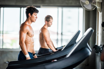 Fototapeta na wymiar handsome man exercising workout in the sport gym, Health concepts, exercise ,and muscle care are the new normal of life that requires health care