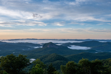 Scenic sunrise view from the Blue Ridge Parkway of Looking Glass Rock, a popular climbing and hiking destination attraction in Pisgah Forest of Brevard, near Asheville, North Carolina