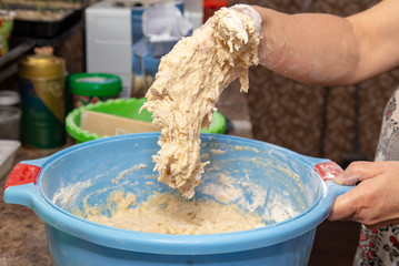 Hand stained in dough with flour.