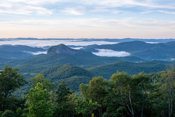 Scenic sunrise view from the Blue Ridge Parkway of Looking Glass Rock, a popular climbing and hiking destination attraction in Pisgah Forest of Brevard, near Asheville, North Carolina