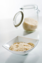 Long grain rice into the white bowl ready for cooking