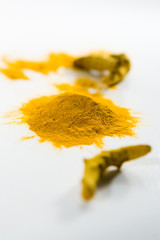Heap of the colorful turmeric on the white table