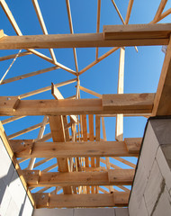 Wooden boards on the roof of the house against the sky.