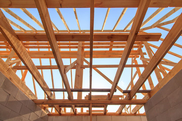 Wooden boards on the roof of the house against the sky.