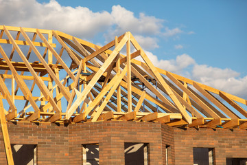 Fototapeta premium Wooden boards on the roof of the house against the sky.