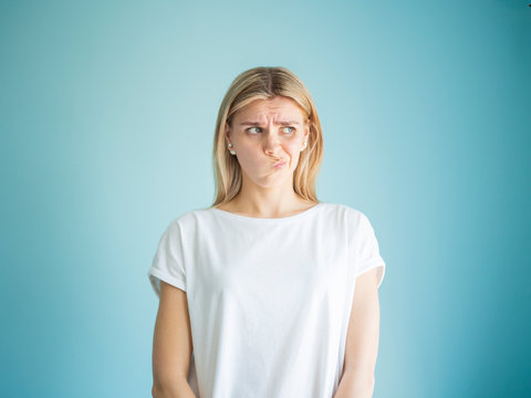 Confused With Curved Lips, Hmm, Let Me Think Facial Expression Blonde Woman Studio Portrait