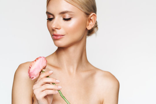 Image of beautiful seductive shirtless woman posing with flower