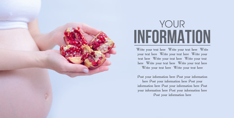 Pregnant woman holding fresh pomegranate on blur gray background, space for text