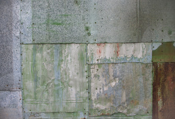 Texture background of corrugated metal fence. Patching stained rusty metal backdrop