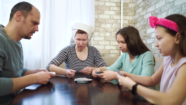 Happy family playing card games together at home