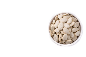  Pumpkin seeds in bowl isolated on white background. Top view. Copy space