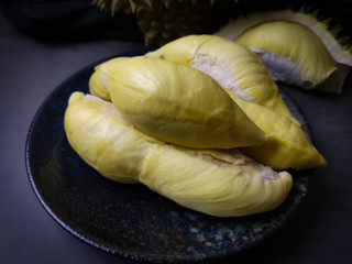 Durian is a popular tropical fruit in Thailand. Betel of durian on black dish on black background.