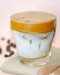 Dalgona frothy coffee trend korean drink with milk on pink pastel background