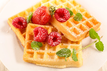 waffle with raspberry, mint leaf and sugar powder
