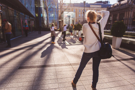 Professional portrait photographer with a model in a photo workshop and participants photographers