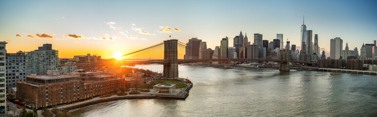 Panoramic view of Brooklyn bridge and Manhattan at sunset, New York City