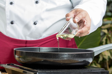 Chef poured oil into the pan.