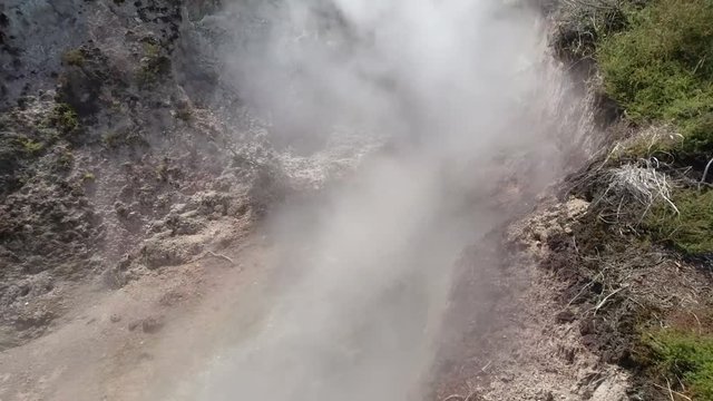 4k hand held tilt panning motion with sound and close up of Crater Fumarole at Craters of the Moon which is a thermal area that has a lot of geothermal activity, Taupo, North Island of New Zealand