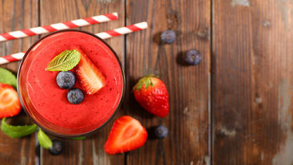 strawberry and blueberry smoothie on white background