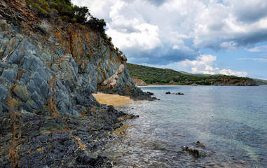 Fototapeta na wymiar Coast with rocks, sea landscape and the beautiful clouds in the blue sky