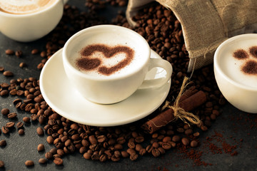 Latte art surrounded with coffee beans
