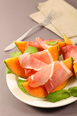 melon sliced with prosciutto ham and basil