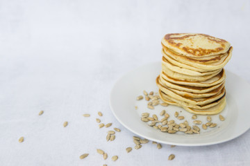 Homemade pancakes on kefir on a white plate. Cooking at home, home-cooked food. Space for text.